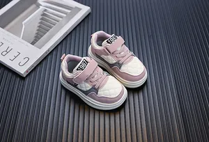 Close-up of children's purple and white quilted sneakers with Velcro strap closure