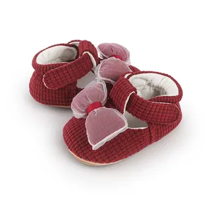 Close-up of wine red baby walker shoes featuring mesh bows and grid texture
