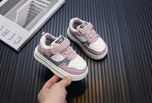 Close-up of quilted pink and white toddler sneakers with Velcro straps