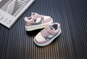 Close-up of pink and white toddler sneakers with quilted texture and velcro strap