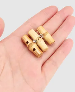 Macro shot of three natural bamboo toggle buttons with metallic rings held in hand