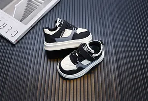 Stylish toddler casual sneakers in black and white with velcro straps and quilted design