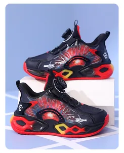 Side view of boys' running shoes with rotary buckle and vibrant red-yellow chunky sole