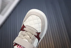 Close-up of toddler sneakers with quilted leather toe and velcro strap for spring