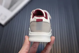 Rear view of children's casual sneakers with quilted beige leather and burgundy lining.
