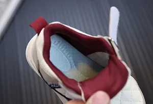 Macro view of breathable blue insole and burgundy inner lining in beige toddler sneakers