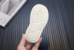 Detail view of anti-slip rubber sole for toddler walking shoes with size 22 marking