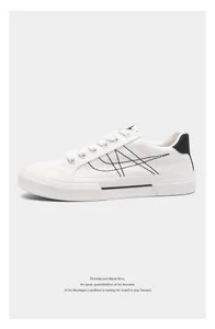 Detail shot of white canvas sneaker with black artistic stitching on minimalist background.