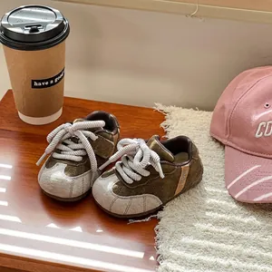 Close-up view of toddler brown suede sneakers with soft soles for daily casual wear.