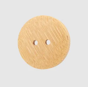 Macro view of a natural bamboo button with vertical grain texture and two holes