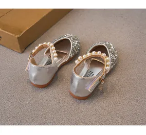 Sparkling silver sequined girls' princess shoes with elegant pearl strap detailing.