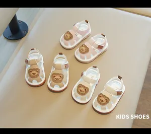 Close-up of infant closed-toe cartoon bear sandals in pink, beige, and cream color options