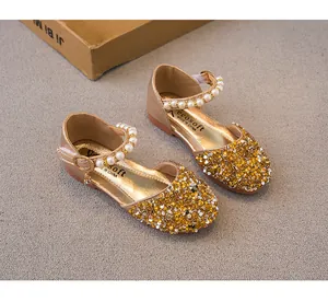 Detailed view of girls champagne sequin princess shoes with elegant pearl strap.