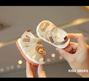 Close-up detail of baby walking sandals featuring a cute cartoon bear and soft non-slip sole