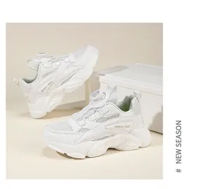 Detailed view of white children's chunky sneakers with convenient dial lacing system.