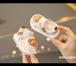 Adorable pink infant walker sandals featuring cartoon bear design and soft anti-slip rubber soles