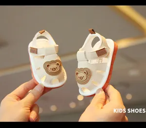 Toddler walking sandals with a cute cartoon bear and soft non-slip orange soles