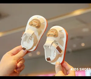 Close-up of soft-soled baby walking shoes with cute cartoon bear design