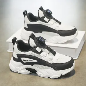Stylish black and white children sneakers with convenient rotary dial lace and chunky soles