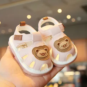 Adorable pink baby walking sandals featuring a cartoon bear and soft non-slip sole for toddlers
