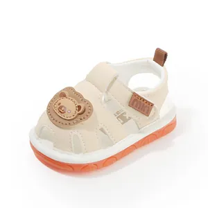Soft beige baby walking shoes with cartoon bear and non-slip orange rubber sole