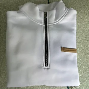 Close-up of a white heavyweight fleece sweatshirt with half-zipper and stand collar