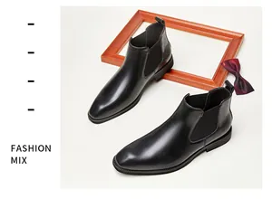 Detailed view of black genuine leather Chelsea boots with square toe and elastic side panel.