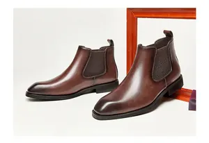 Detail view of retro brown leather Chelsea boots featuring square toe design and elastic