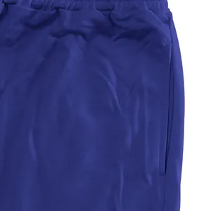 Close-up detail of blue men's joggers showing elastic waistband and side pocket fabric