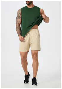Detailed view of men's dark green quick-dry sleeveless sports vest and mesh shorts