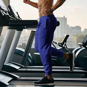 Action shot of men's royal blue slim fit joggers for gym training and running