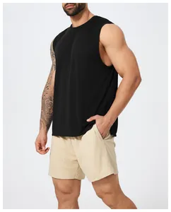 Side view of a man wearing a black athletic tank top and mesh shorts for gym training