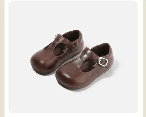 Vintage brown leather T-strap girls' shoes with round toe and silver buckle detail