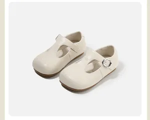 Top view of beige girls' T-strap leather shoes with round toe and metallic buckle