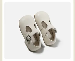 Close-up detail of beige children's T-strap Mary Jane shoes with soft leather