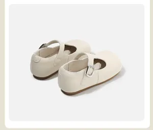 Back view of cream Mary Jane shoes for girls with classic silver buckle and soft sole