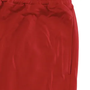 Close-up detail of pocket and waistband on red athletic jogger sweatpants for men