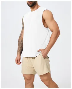 Detailed close-up showing the fit of a white quick-dry athletic tank top for men's fitness