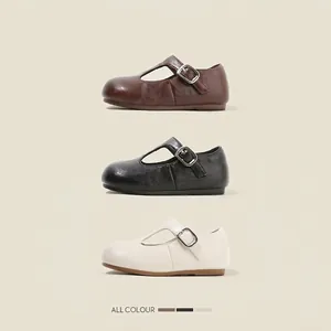 Classic girl's round toe Mary Jane leather shoes available in brown, black, and cream colors