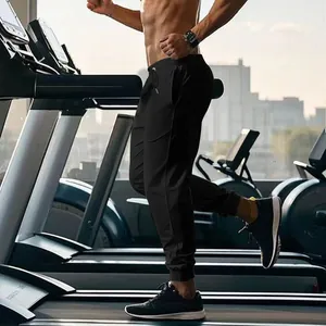 Detailed close-up of men's black athletic jogger pants being worn during a gym workout