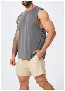 Close-up detail of gray quick-dry sleeveless tank top and beige mesh shorts on muscular male model