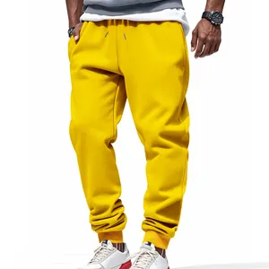 Front view of vibrant yellow men's athletic joggers featuring drawstring and cuffs