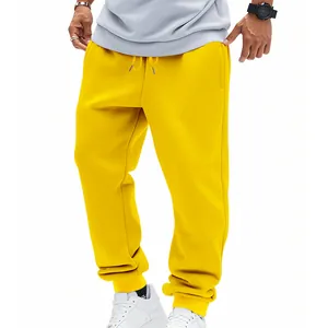 Close-up detail shot of men's bright yellow French Terry joggers for athletic workout wear