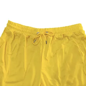 Detail view of yellow men's french terry joggers with drawstring elastic waistband