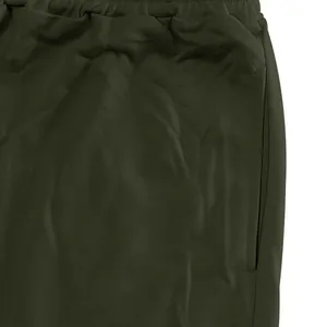 Detailed view of dark green men's joggers featuring elastic waistband and side pocket