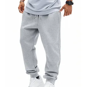 Macro detail of men's gray French terry sweatpants featuring a comfortable drawstring waist.