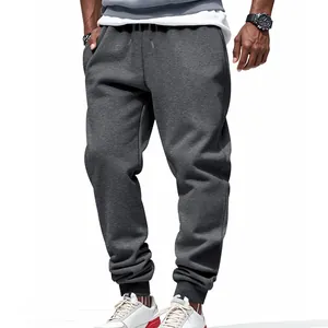 Detail view of dark grey men's joggers with elastic cuffs and soft fabric texture