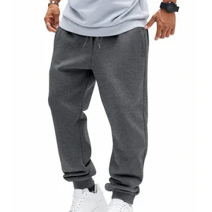Detailed full-length view of men's grey sports joggers on a model in white sneakers