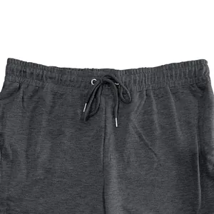 Close-up of dark grey men sweatpants featuring an adjustable elastic waistband and drawstrings.