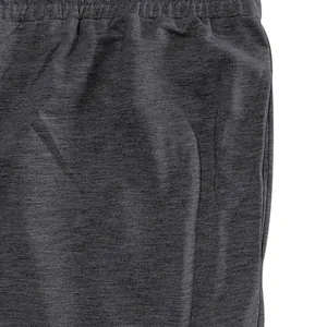 Close-up of charcoal grey men's joggers showing elastic waistband and fabric texture